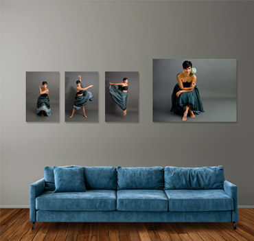 Four mounted prints on wall over blue couch